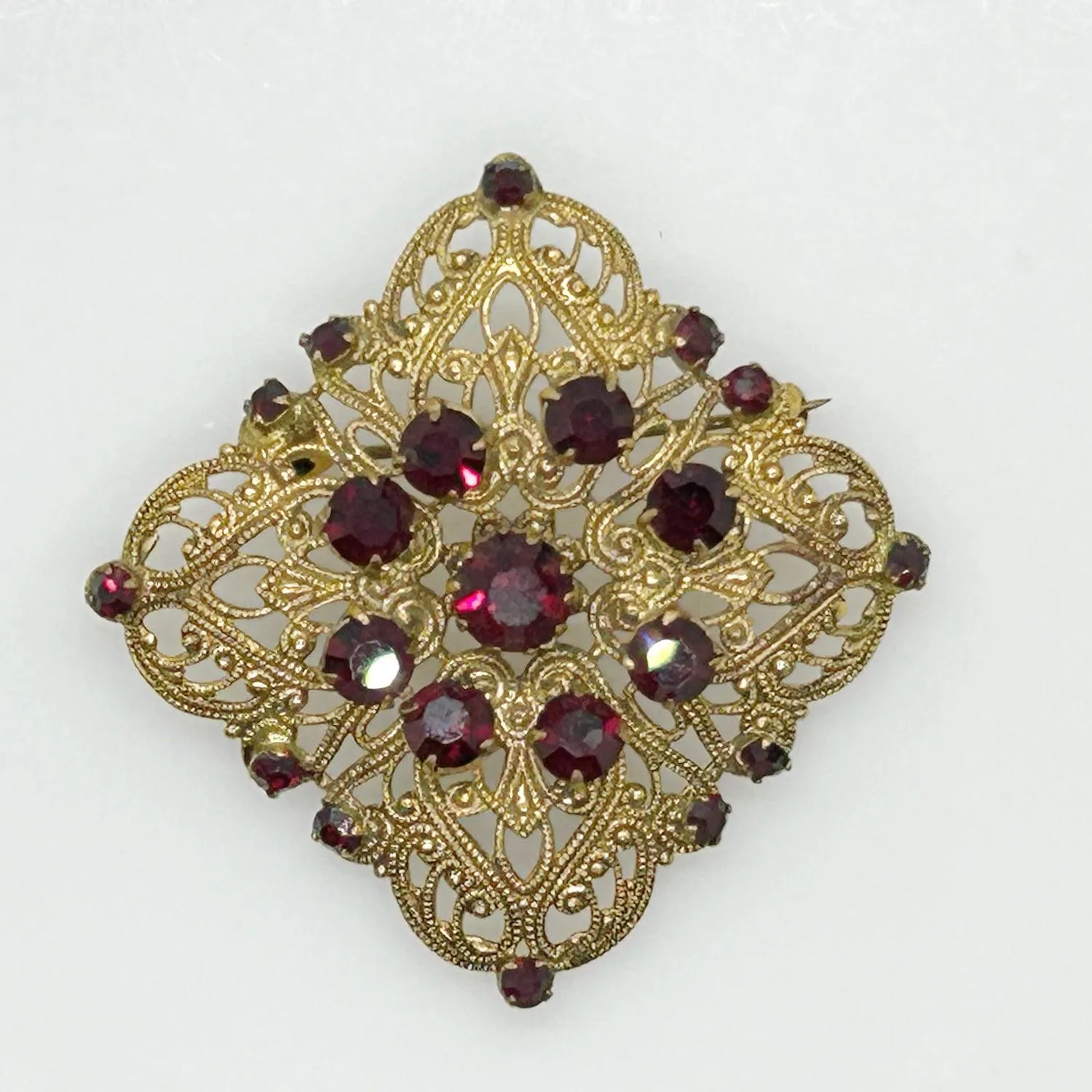 Intricate Vintage Gold Tone Brooch with Ruby Red Stones