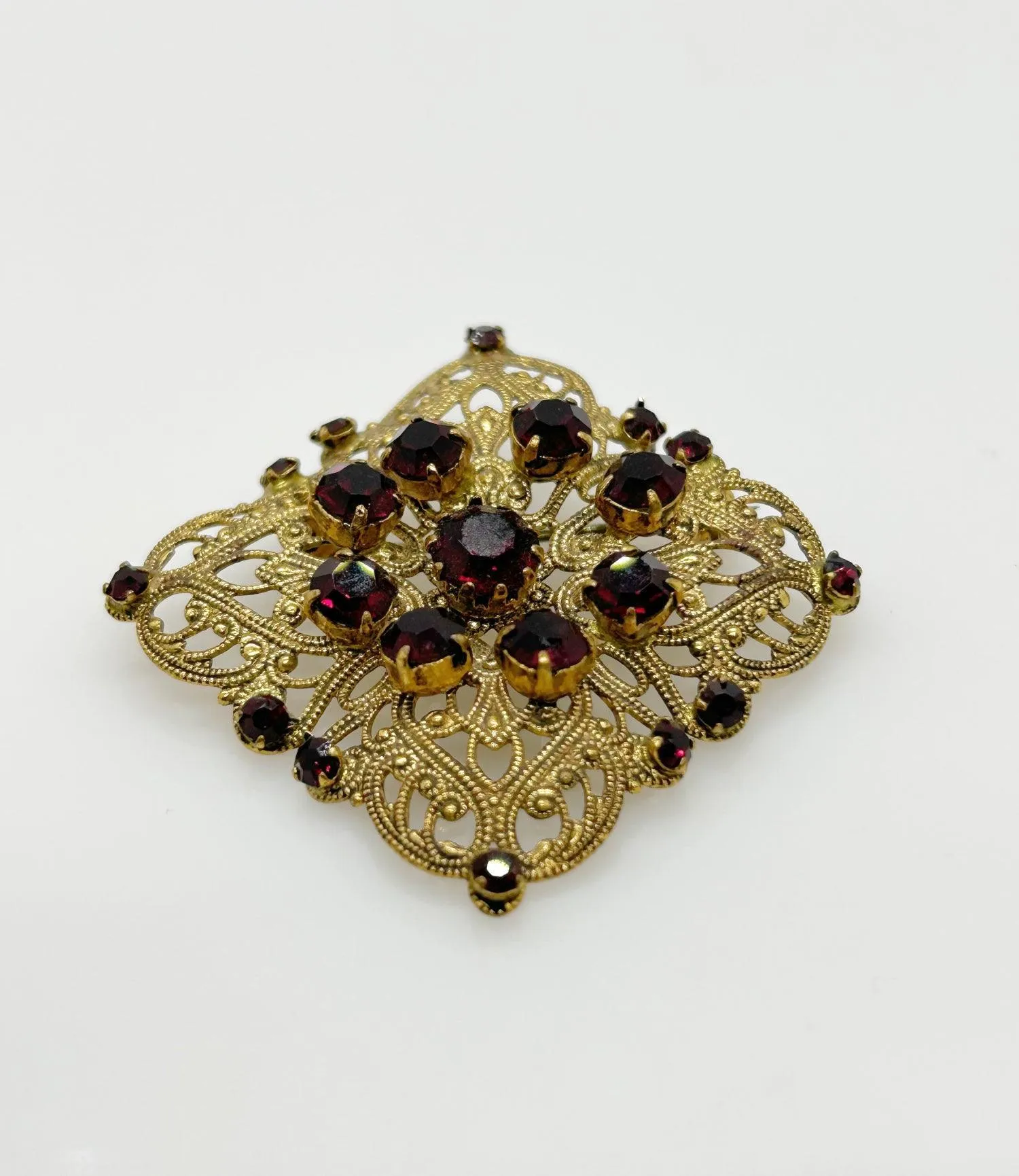 Intricate Vintage Gold Tone Brooch with Ruby Red Stones