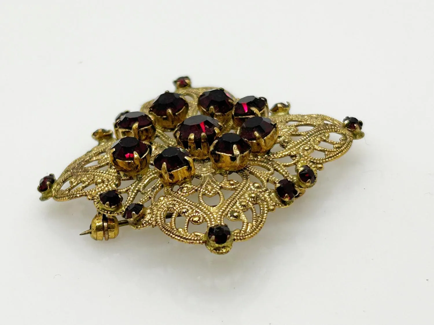 Intricate Vintage Gold Tone Brooch with Ruby Red Stones